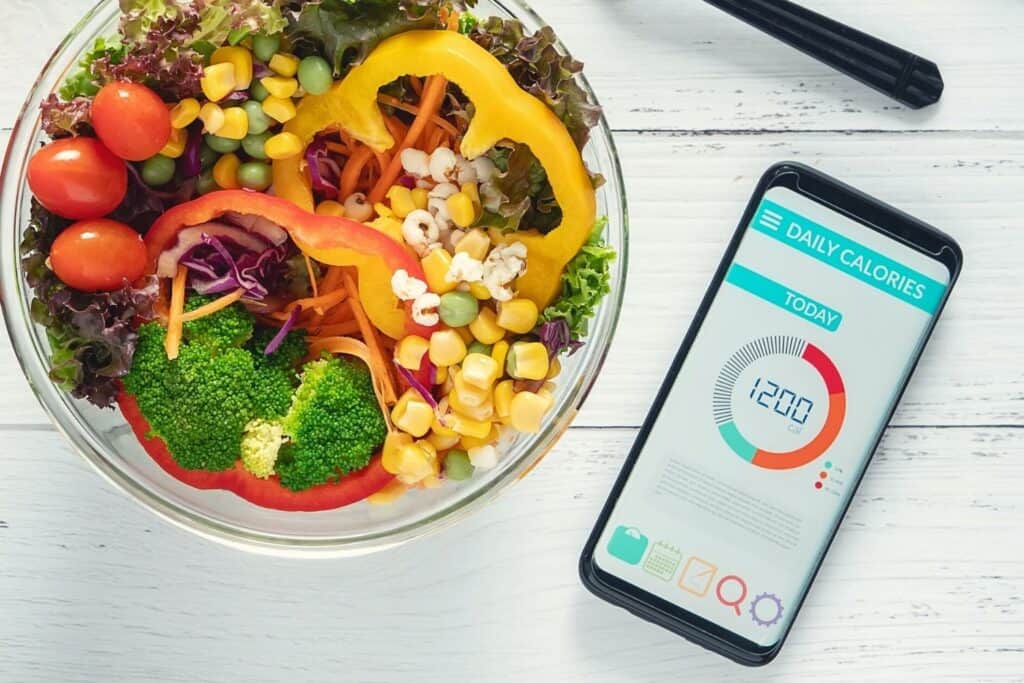 une application de suivi des calories sur un smartphone aide à courir pour maigrir